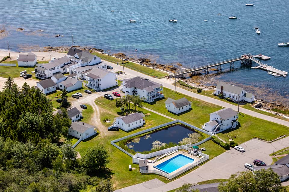 Coastal residential community with white cottages, boats, and waterfront docks
