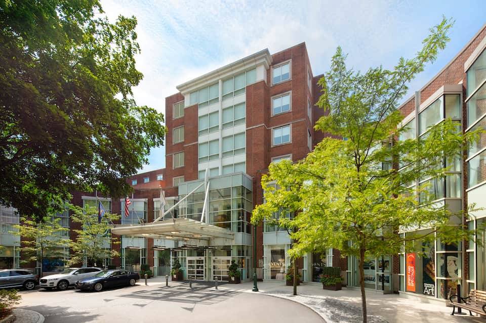 Urban hotel entrance with brick facade and glass doors