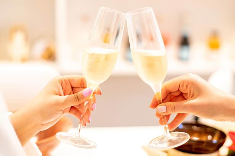 Two champagne glasses clinking in a toast at a celebration or event