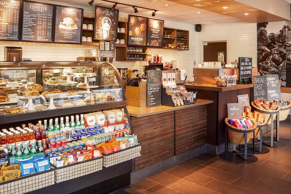 Bakery café interior with display cases of pastries, breads, and coffee bar with menu boards