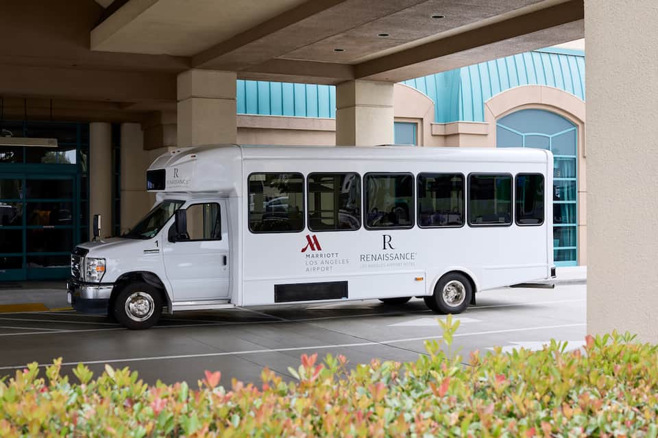 White shuttle bus branded with Marriott Renaissance Los Angeles Airport logo