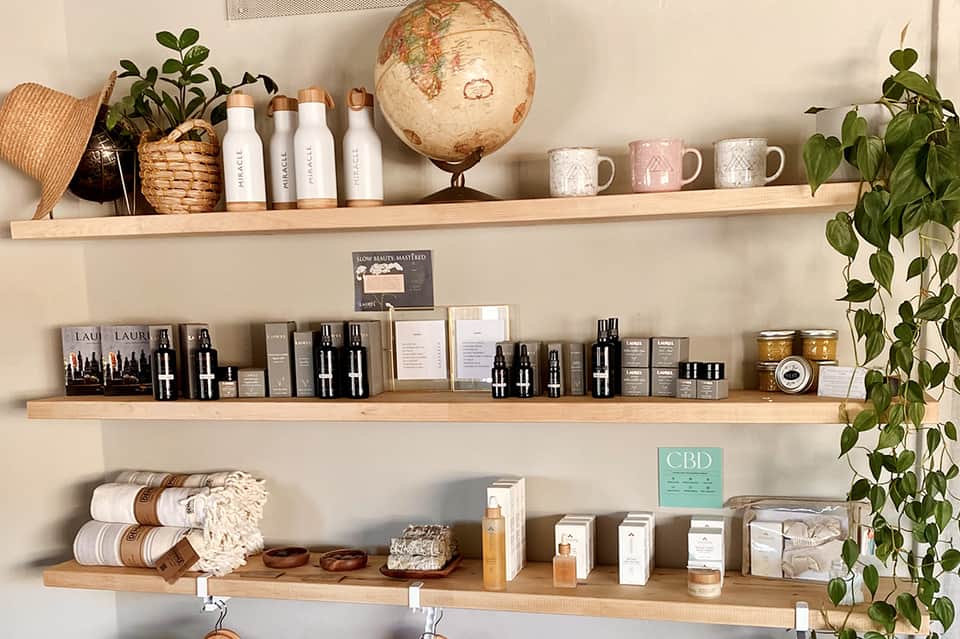Retail shelving displaying skincare products, cosmetics, and decorative items