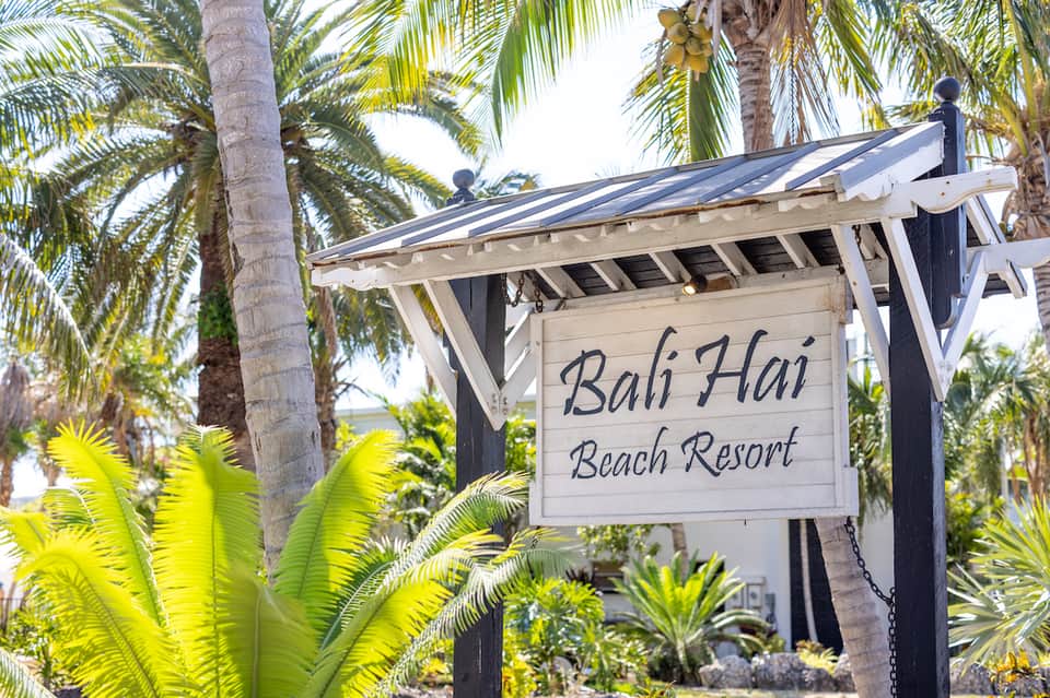 Bali Hai Beach Resort sign among palm trees and tropical vegetation