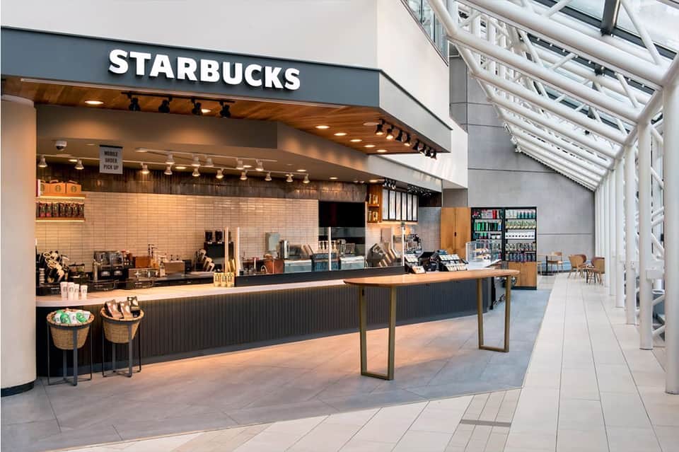 Starbucks café interior with counter service, wooden accents, and skylight ceiling