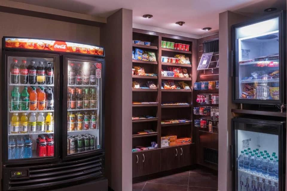 Convenience store with refrigerated beverage displays, snack shelves, and candy selections