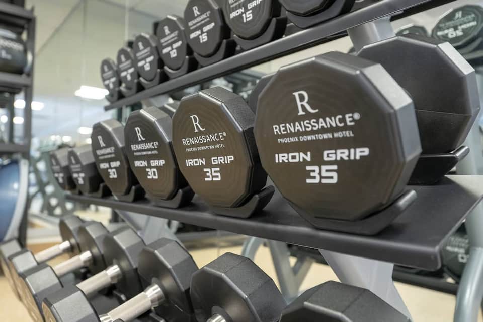 Close-up of dumbbells with Renaissance hotel branding in gym fitness facility