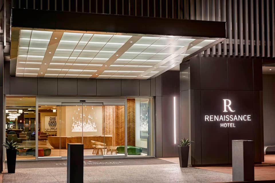 Renaissance Hotel modern entrance with illuminated ceiling, dark facade, and contemporary glass storefront at night