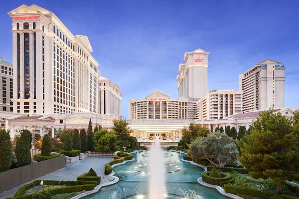 Luxury casino resort with fountains, manicured gardens, and classical architecture