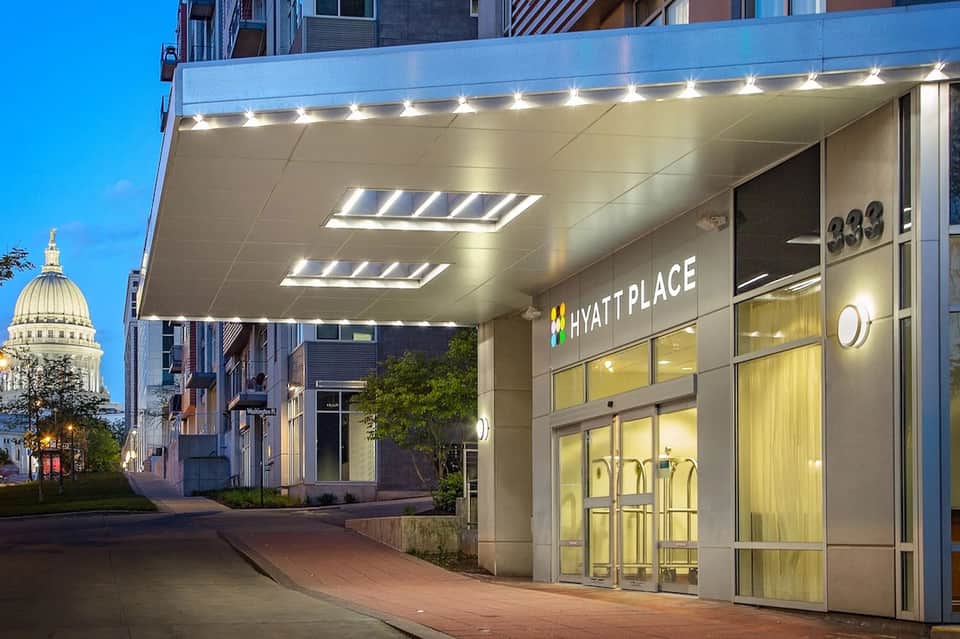 Hyatt Place hotel entrance at dusk with modern canopy and illuminated signage