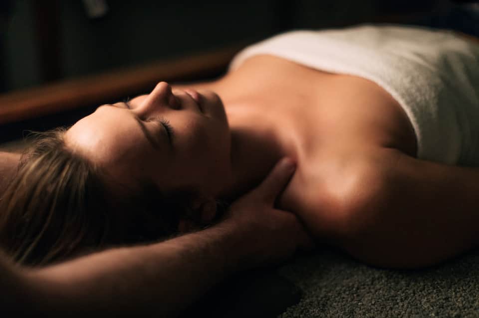 Woman receiving a relaxing spa massage treatment on a massage table