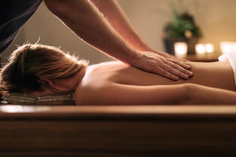 Woman receiving a professional massage on a spa treatment table in a wellness setting