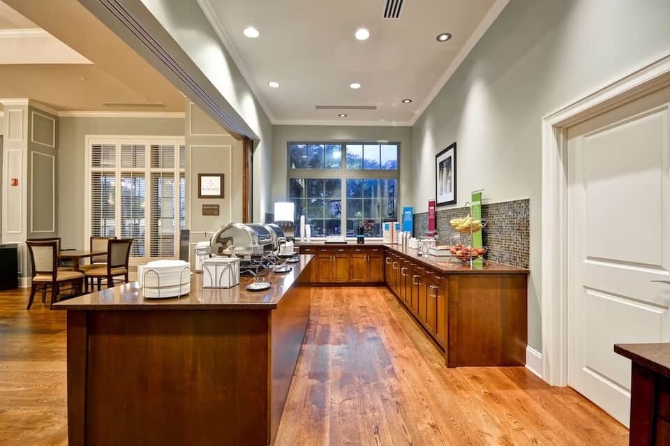 Luxury kitchen with wooden cabinetry, granite countertops, and glass-paned doors