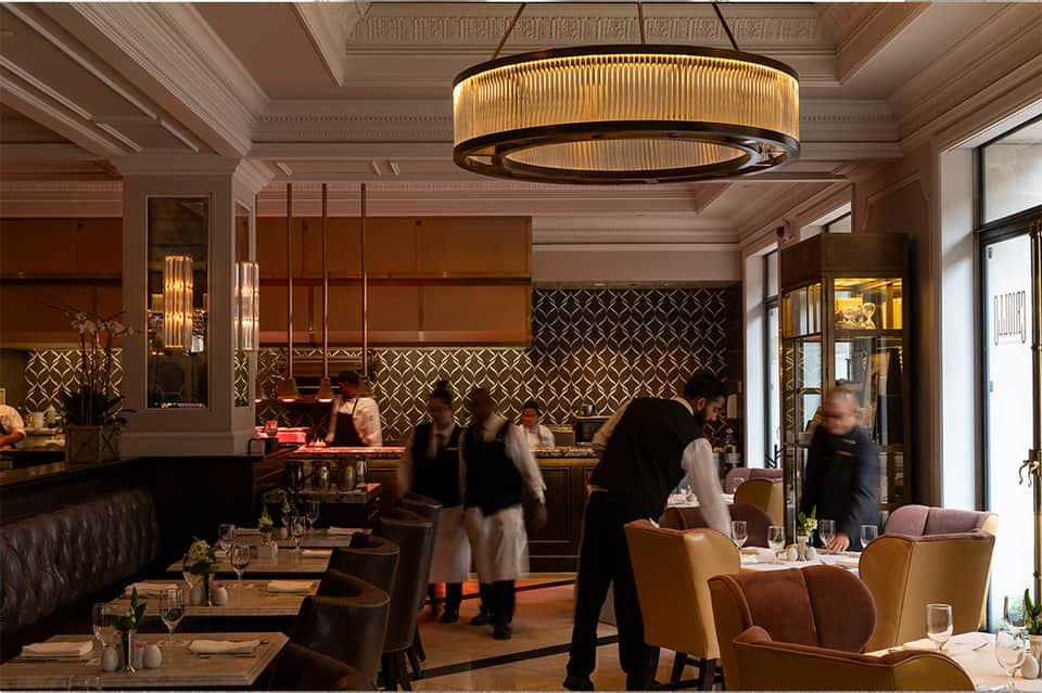 Upscale restaurant interior with warm lighting, geometric wall patterns, and elegant dining setup