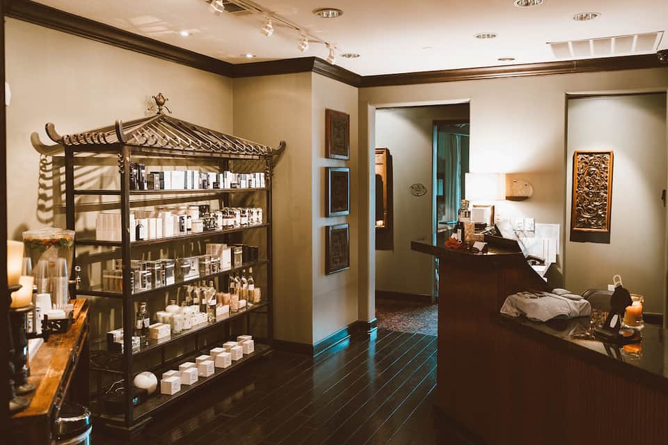 Spa reception area with decorative Asian-inspired shelving and product displays