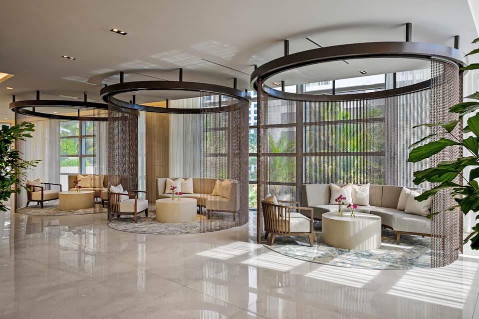 Contemporary spa lounge with circular mesh-enclosed seating areas and cream-colored furnishings
