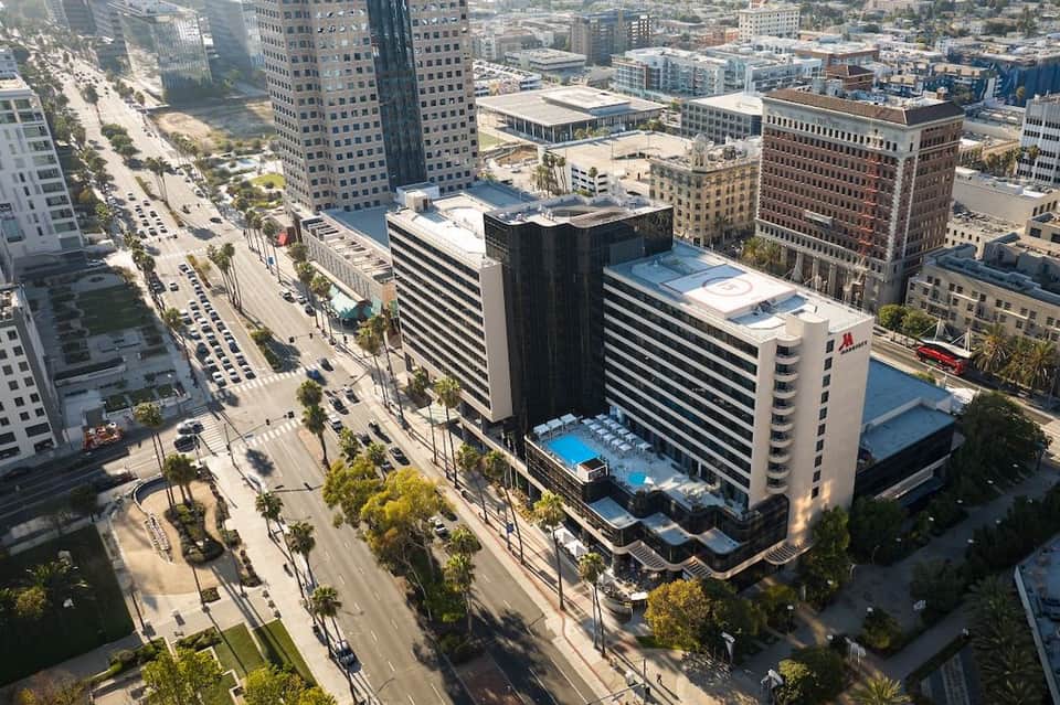 Aerial view of downtown hotel with rooftop pool surrounded by urban buildings