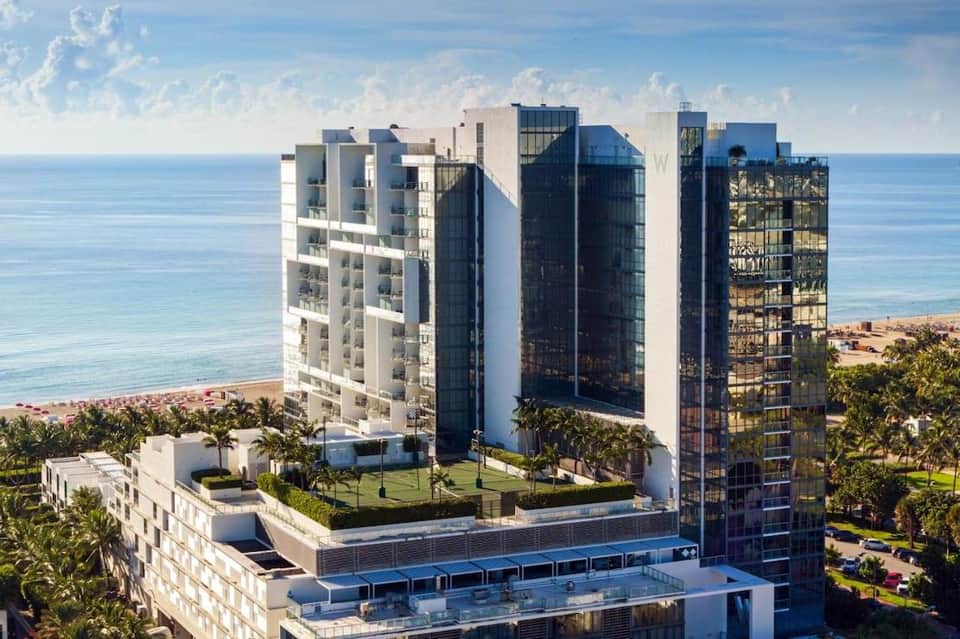 Modern beachfront high-rise resort towers with ocean view, contemporary architecture, and landscaped grounds