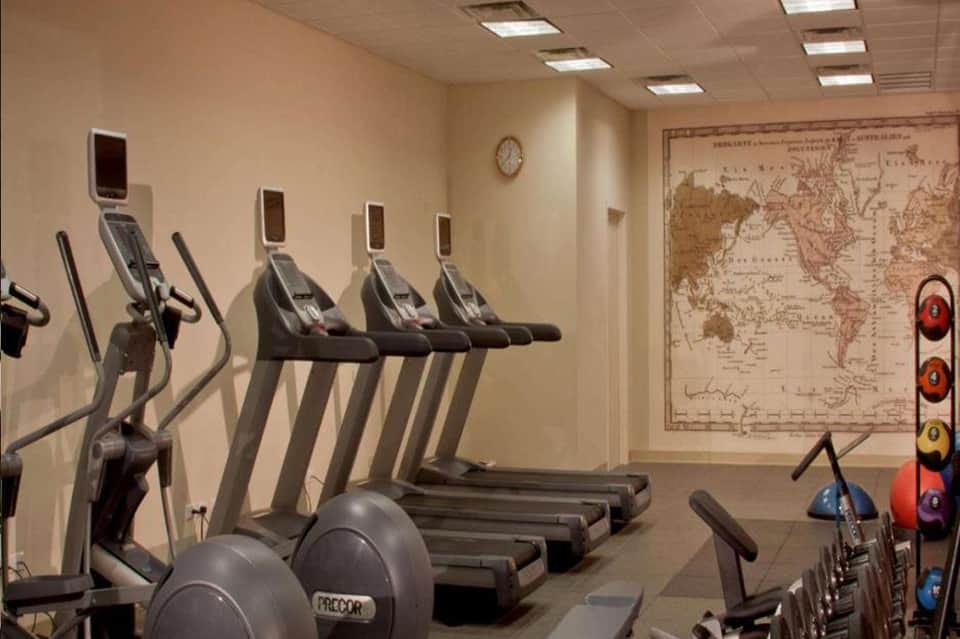 Fitness center with exercise equipment, treadmills, and world map on wall