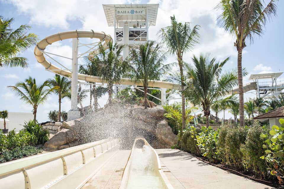 Water slide at Baha Bay water park with palm trees and splash effect