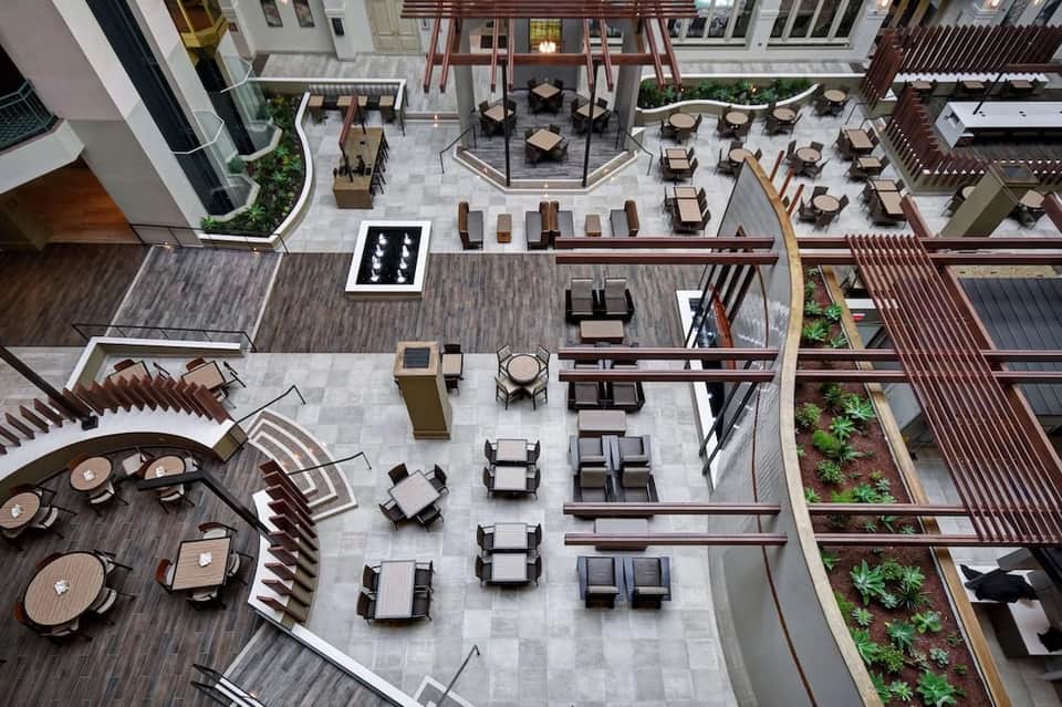 Aerial view of multi-level outdoor courtyard with seating areas, lounge chairs, and landscaping