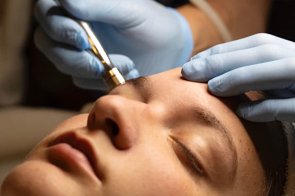 Close-up of professional facial treatment being performed with handheld device