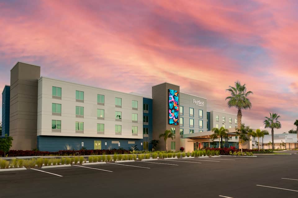 Fairfield hotel exterior at dusk with modern architecture and tropical landscaping