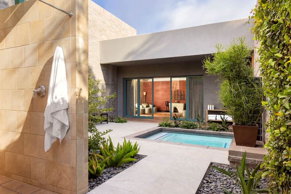 Modern courtyard with outdoor shower, small pool, and contemporary architecture