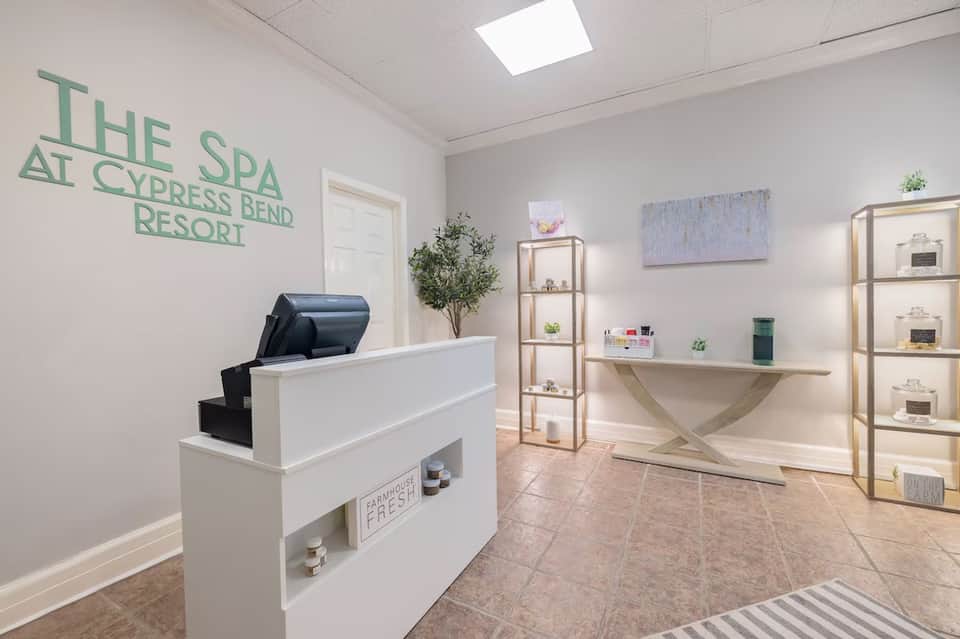 The Spa at Cypress Bend Resort reception area with white desk and shelving