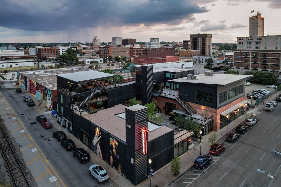 Rooftop aerial view of urban hotel with black shipping container architecture