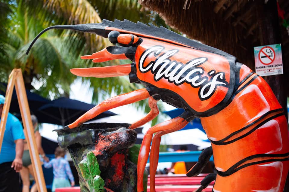 Red Gatorade mascot statue holding beverage sign with palm trees and smoke-free zone sign