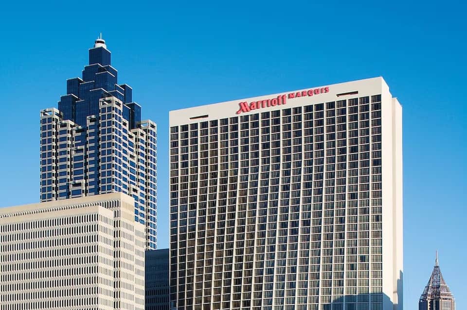 Urban Marriott Marquis building among downtown skyscrapers under blue sky