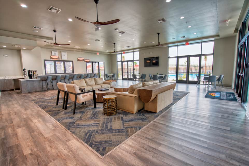 Contemporary resort lobby with curved seating, coffee bar, and ocean-view terraces