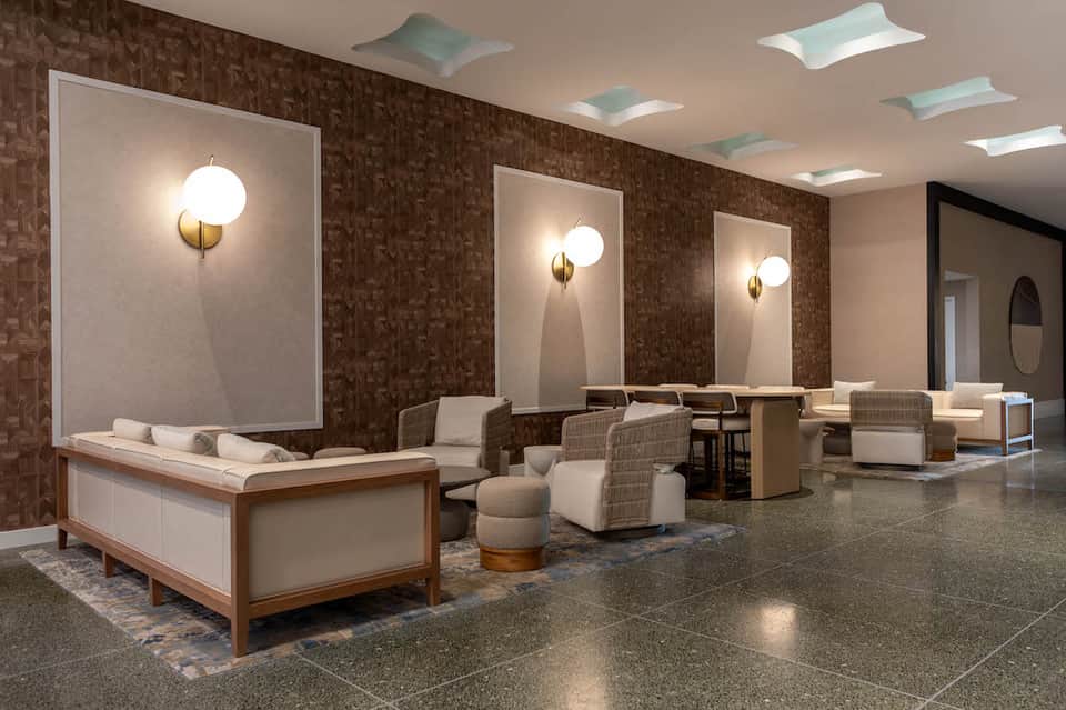 Spa relaxation room with brown textured walls, cream seating, and ambient wall lighting