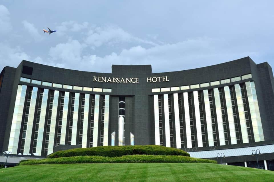 Renaissance Hotel exterior with distinctive curved dark facade and manicured green lawn