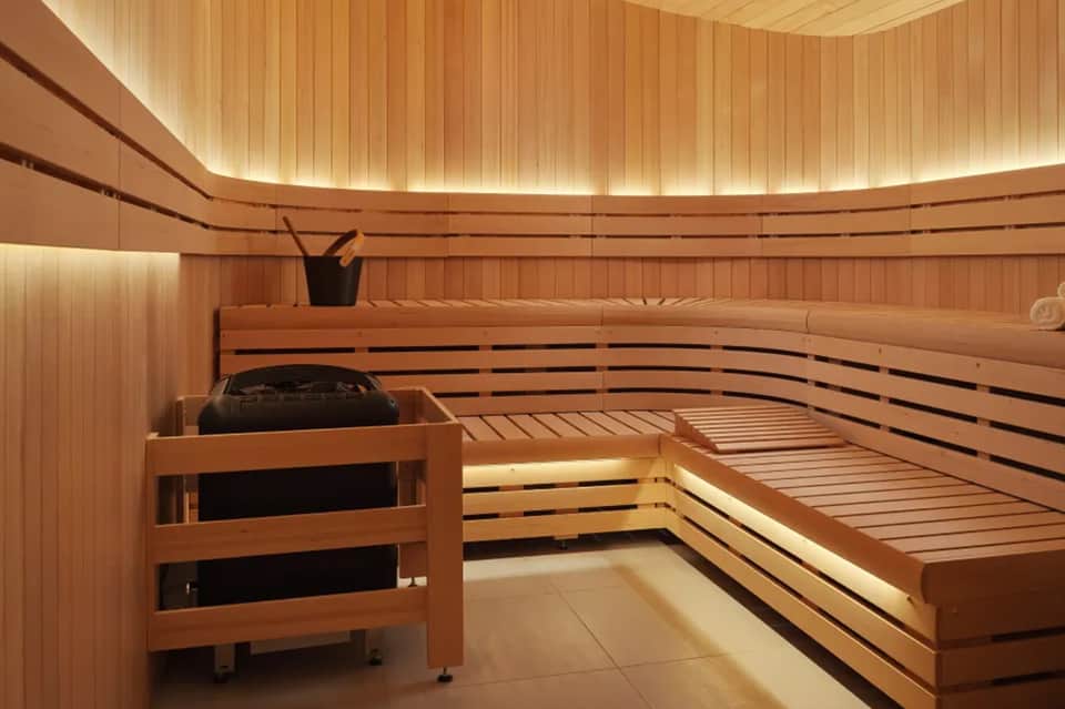 Modern sauna interior with wooden benches and ambient lighting