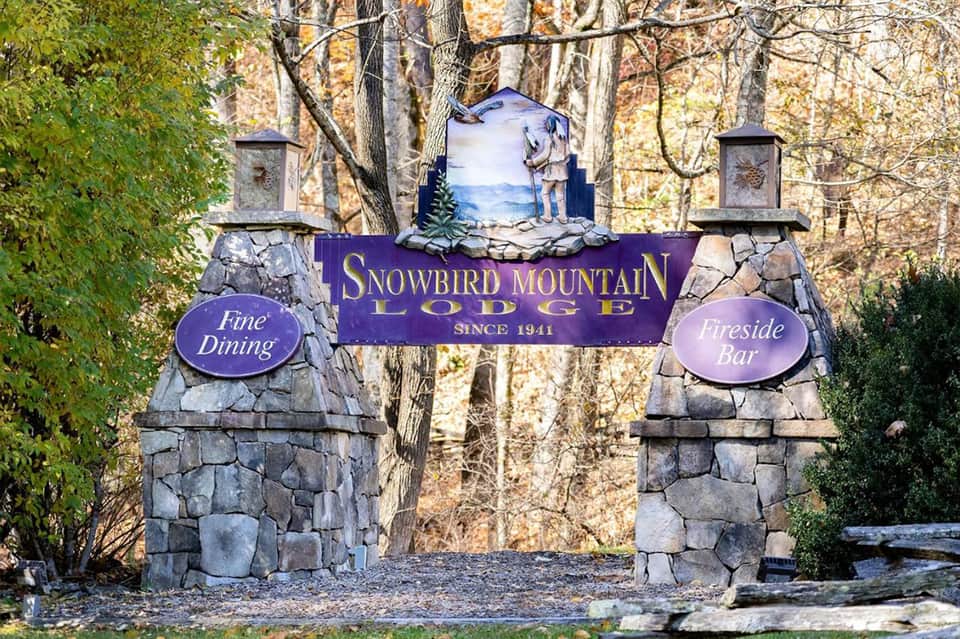 Stone entrance gate to Snowbird Mountain Lodge with fine dining and fireside bar signage