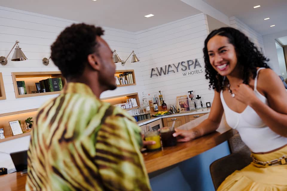 Hotel spa receptionist greeting guest at AWAYSPA W Hotels counter