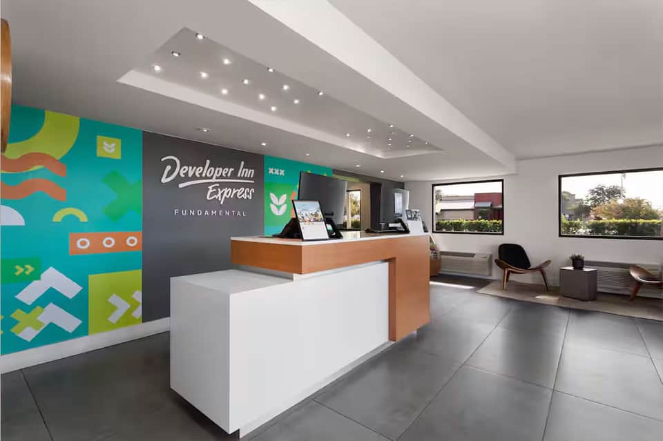 Developer Inn Express hotel lobby with colorful wall art and reception desk