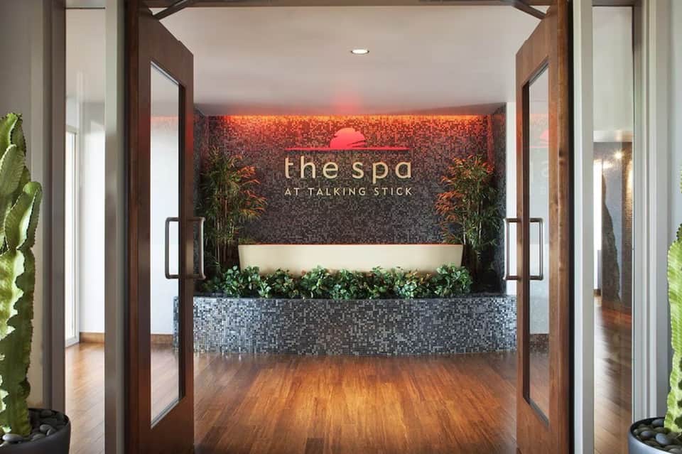 Modern spa reception area with warm lighting and living plant wall