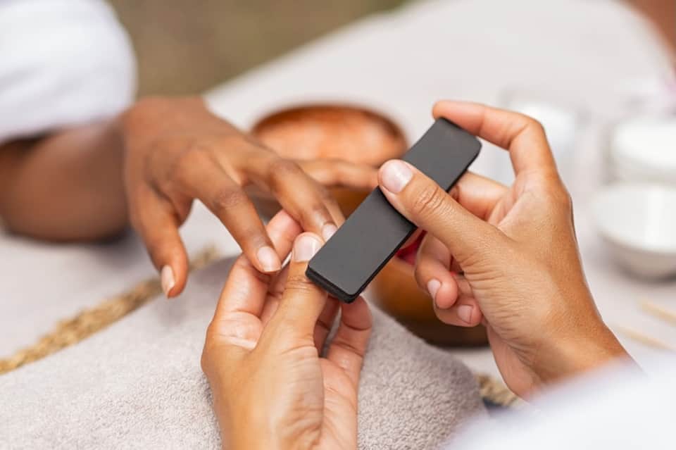 Hands holding a black fitness tracker or smartwatch during a wellness session