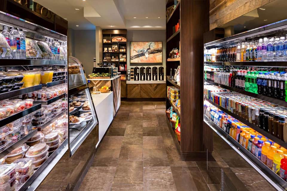 Hotel convenience store interior with refrigerated displays of beverages and food products
