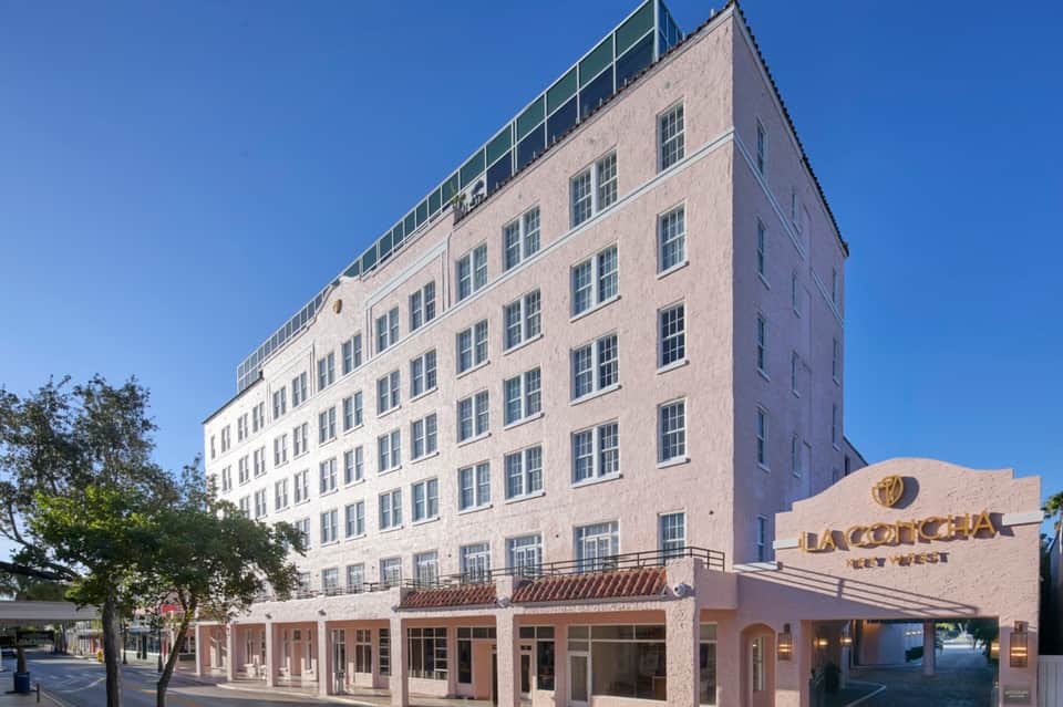 Historic La Concha Hotel building in Key West with beige facade and ground-level retail storefronts