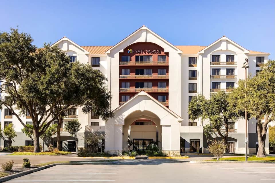 Hyatt Place hotel exterior showing white and brick multi-story building with covered entrance