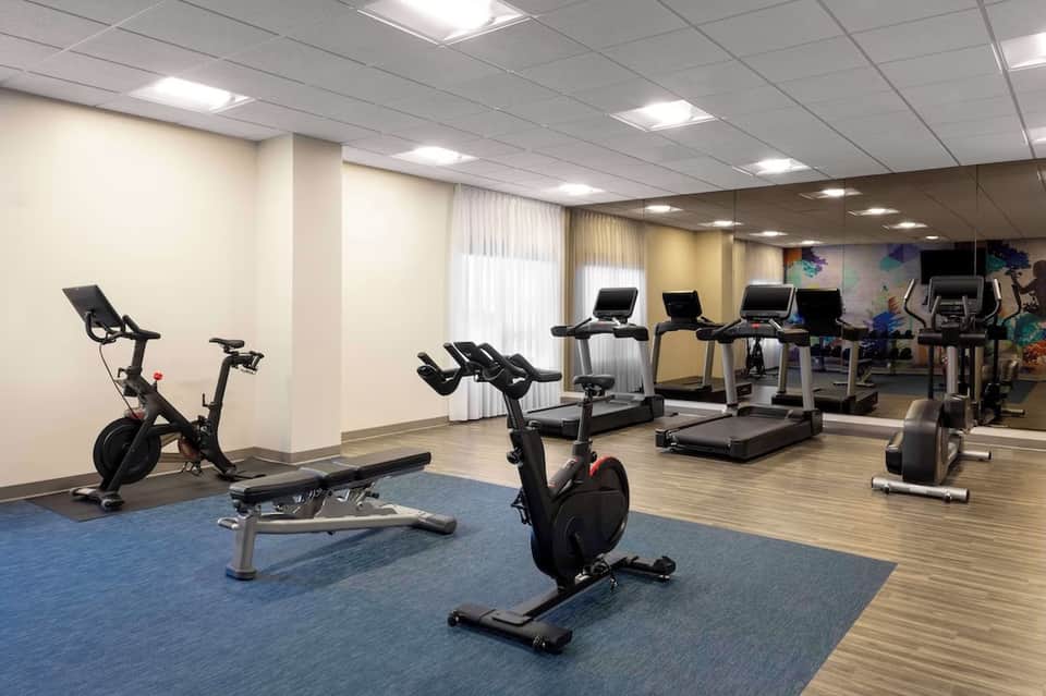 Modern fitness center with stationary bikes, treadmills, and exercise equipment