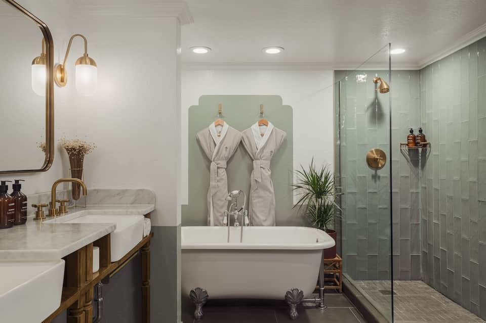Luxury bathroom with freestanding soaking tub, dual sinks, walk-in shower, and spa amenities