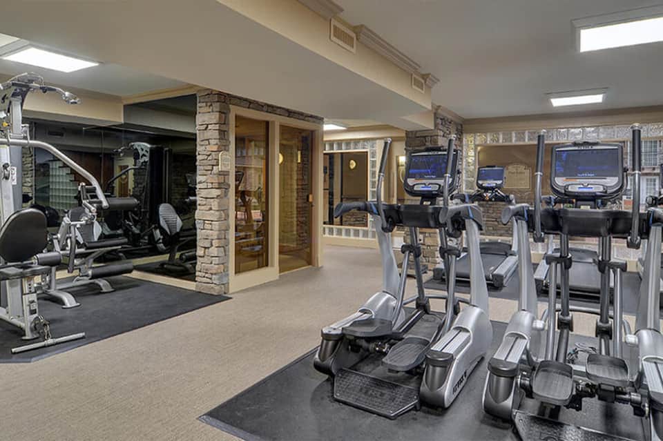Modern fitness center with cardio equipment, exercise bikes, and treadmills in spacious room
