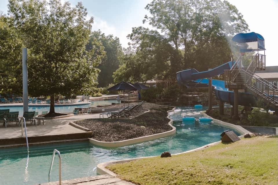 Water park with lazy river, slides, pools, and surrounding trees
