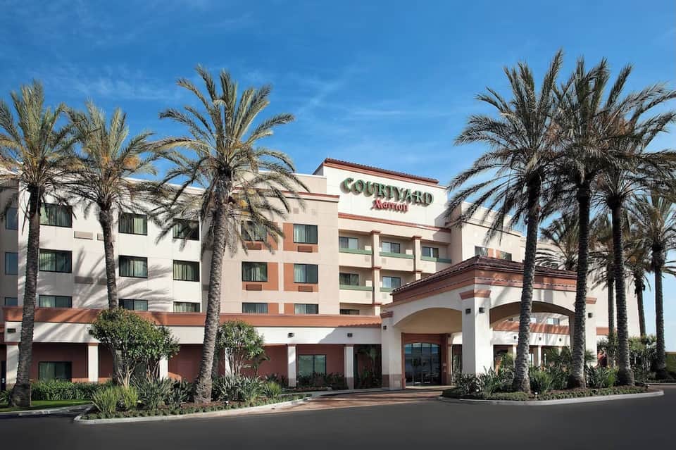 Courtyard Marriott hotel exterior with palm trees and terracotta architectural details