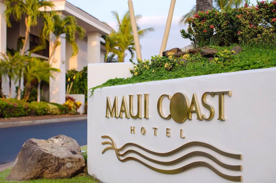Maui Coast Hotel entrance sign with tropical landscaping and palm trees