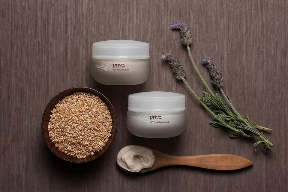 Spa products display with exfoliating scrubs, lavender sprigs, and wooden applicator